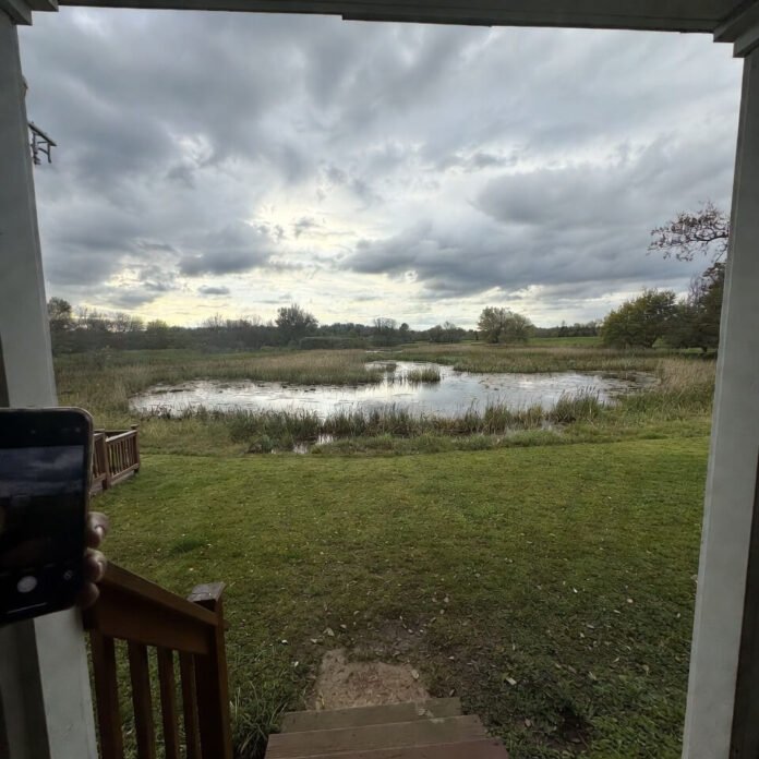 Shaky phone capturing stormy yard flooding from porch steps. Shaky phone capturing stormy yard flooding from porch steps.
