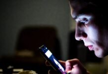 Breaking Tech News: Updates That Are Changing the Digital World Late-night phone glow on unshaven face with taco